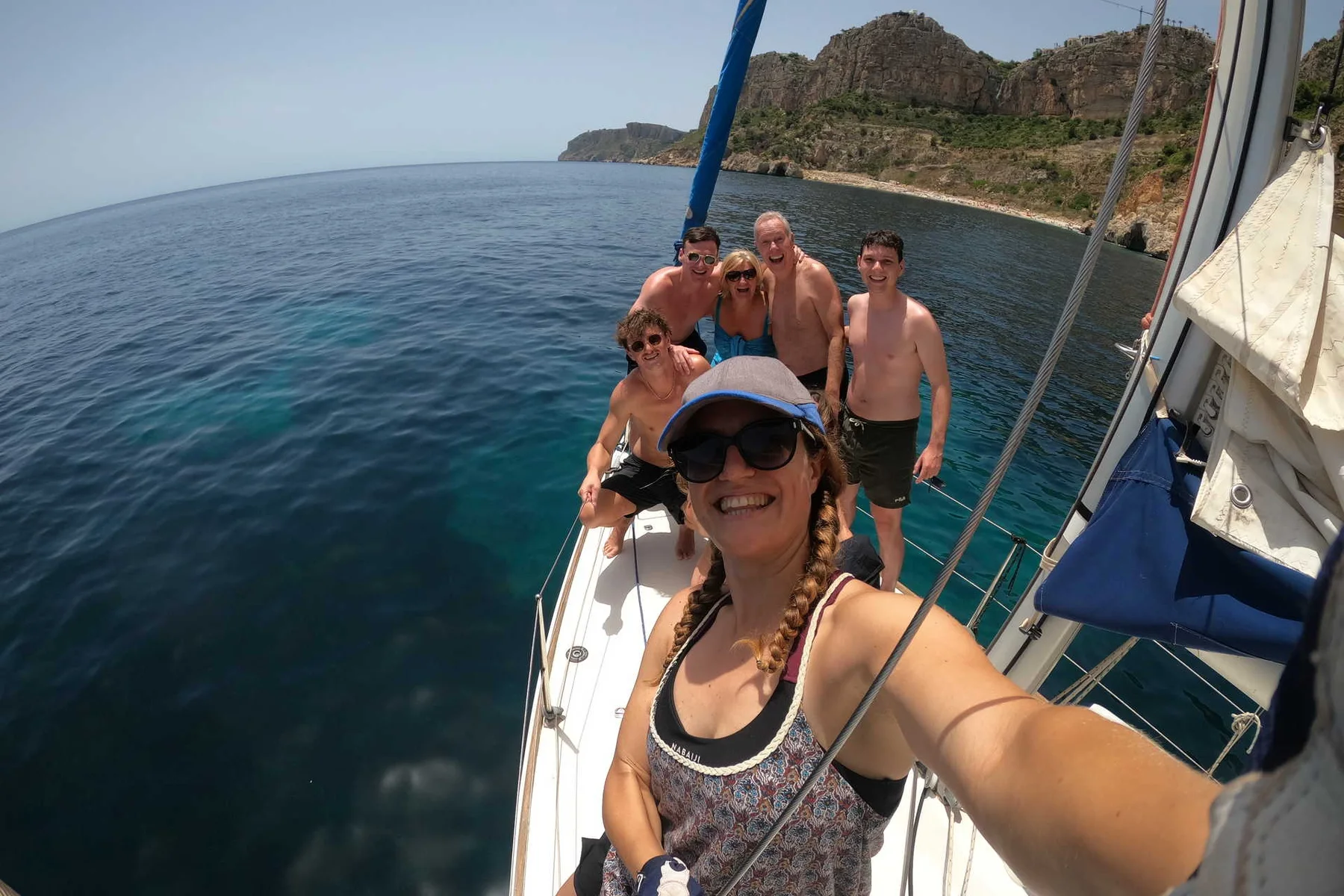 Friends on a sailing boat over turquoise water